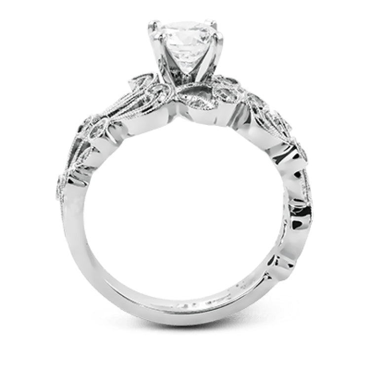 This delicate floral inspired white gold engagement ring and wedding band set is accentuated with .28 ctw shimmering round cut white diamonds.