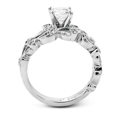 This delicate floral inspired white gold engagement ring and wedding band set is accentuated with .28 ctw shimmering round cut white diamonds.