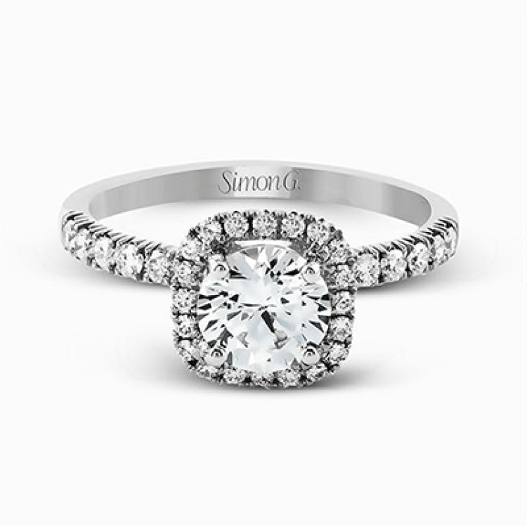 This elegant classic white gold halo engagement ring and band is set with .78 ctw of sparkling round cut white diamonds.