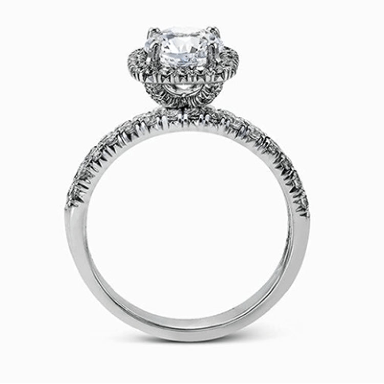 This elegant classic white gold halo engagement ring and band is set with .78 ctw of sparkling round cut white diamonds.