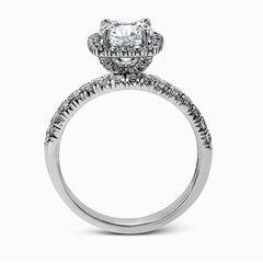 This elegant classic white gold halo engagement ring and band is set with .78 ctw of sparkling round cut white diamonds.
