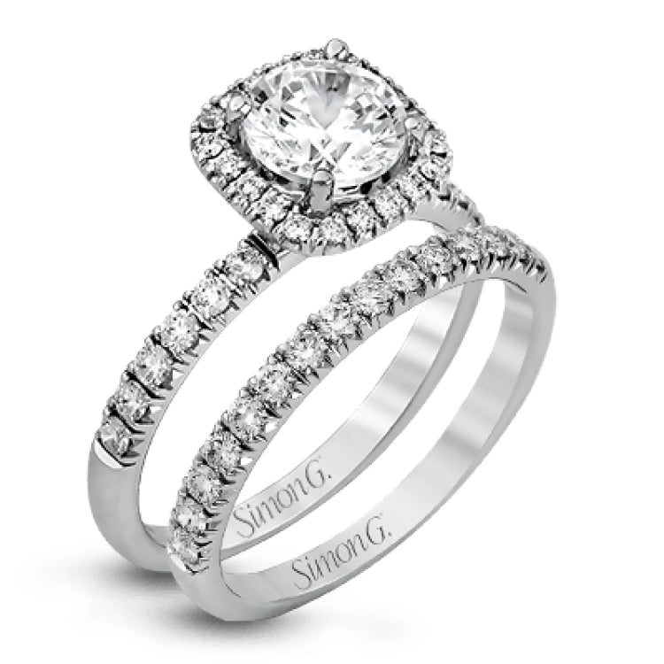 This elegant classic white gold halo engagement ring and band is set with .78 ctw of sparkling round cut white diamonds.