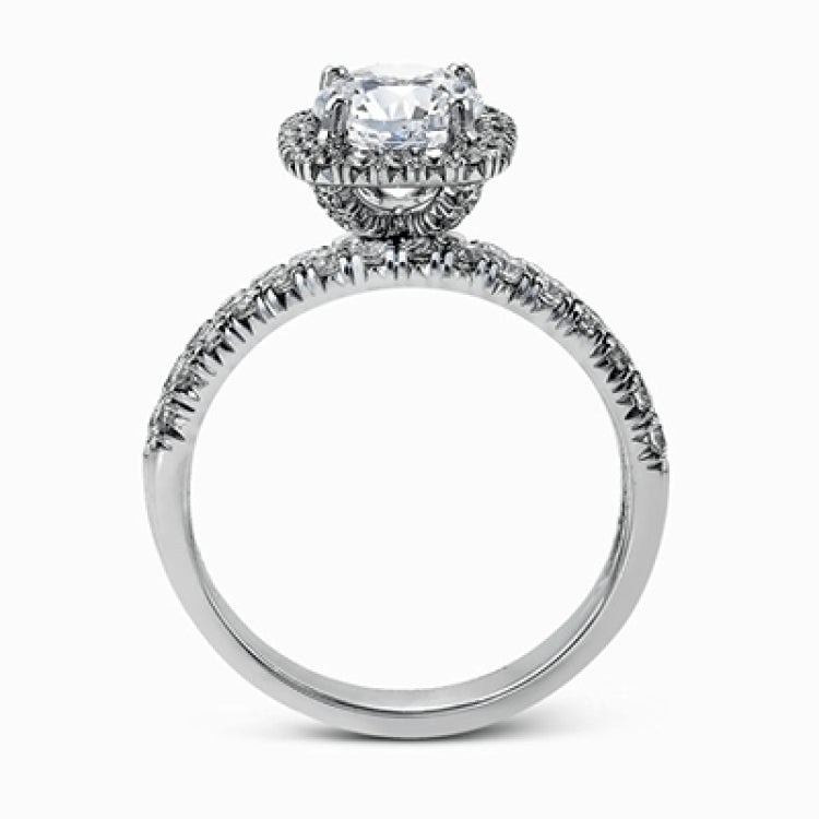This elegant classic white gold halo engagement ring and band is set with .78 ctw of sparkling round cut white diamonds.