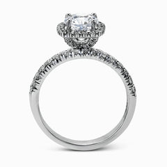 This elegant classic white gold halo engagement ring and band is set with .78 ctw of sparkling round cut white diamonds.