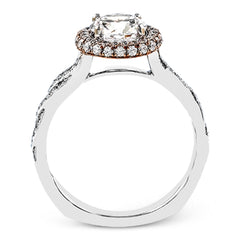 Featuring an elegant twisted contemporary design, this white and rose gold engagement ring complemented by .51 ctw of shimmering round cut white diamonds.