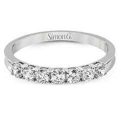 Elegantly simple, this classically styled white gold band is accented by the presence of .50 ctw of shimmering round cut white diamonds.