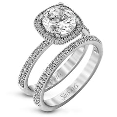 Featuring a contemporary take on a vintage style, this white gold engagement ring and band is complemented by .50 ctw of striking round cut white diamonds.