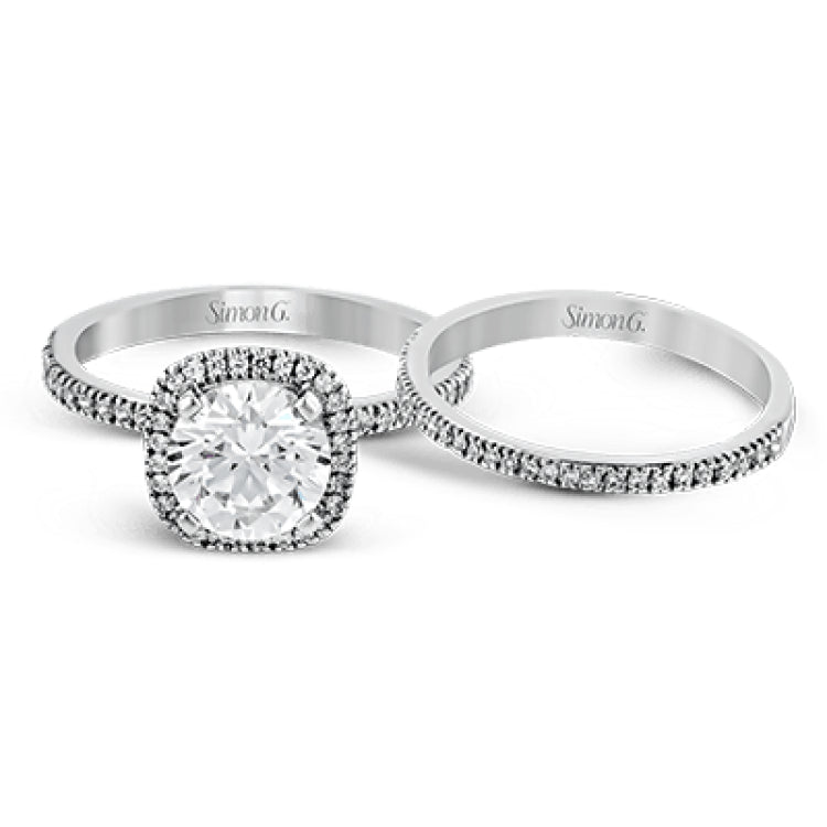 Featuring a contemporary take on a vintage style, this white gold engagement ring and band is complemented by .50 ctw of striking round cut white diamonds.