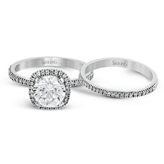 Featuring a contemporary take on a vintage style, this white gold engagement ring and band is complemented by .50 ctw of striking round cut white diamonds.