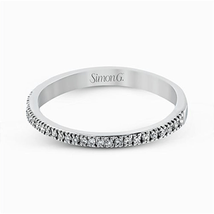 Featuring a contemporary take on a vintage style, this white gold engagement ring and band is complemented by .50 ctw of striking round cut white diamonds.