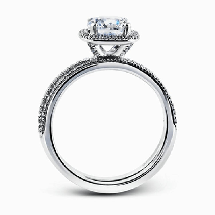 Accented by .46 ctw of glistening round cut white diamonds, this contemporary white gold halo style engagement ring and wedding band set makes a dramatic statement.