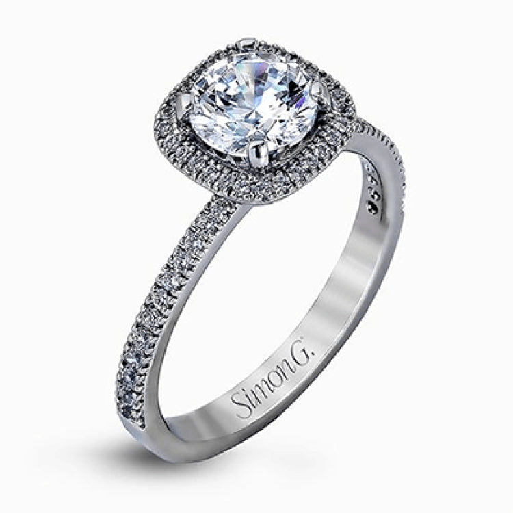 Accented by .46 ctw of glistening round cut white diamonds, this contemporary white gold halo style engagement ring and wedding band set makes a dramatic statement.