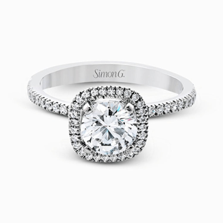 Accented by .46 ctw of glistening round cut white diamonds, this contemporary white gold halo style engagement ring and wedding band set makes a dramatic statement.