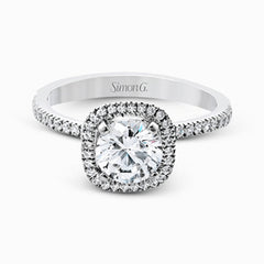 Accented by .46 ctw of glistening round cut white diamonds, this contemporary white gold halo style engagement ring and wedding band set makes a dramatic statement.