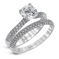 The classic design of this white gold engagement ring and wedding band set is emphasized by .72 ctw round cut white diamonds.