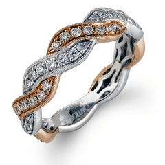 Featuring a dynamic two-tone twist design, this yellow and white gold contemporary ring is set with .53 ctw of round cut white diamonds.