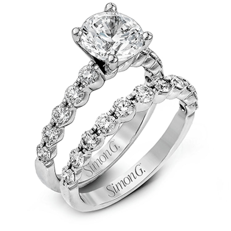 This marvelous white gold wedding set highlights its center stone with 1.19 ctw of round white diamond accents.