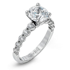 This marvelous white gold wedding set highlights its center stone with 1.19 ctw of round white diamond accents.