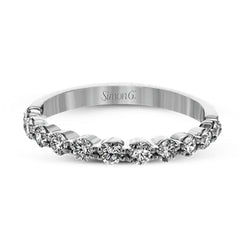 This marvelous white gold wedding set highlights its center stone with 1.19 ctw of round white diamond accents.
