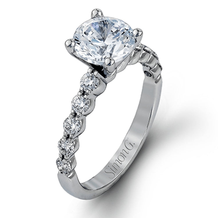 This marvelous white gold wedding set highlights its center stone with 1.19 ctw of round white diamond accents.