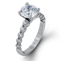 This marvelous white gold wedding set highlights its center stone with 1.19 ctw of round white diamond accents.