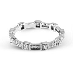 This white gold band form a modern style band set with .33 ctw of striking round cut white diamond accents. Perfect for stacking.