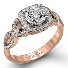 This impressive white gold engagement ring is accented by .23 ctw white round cut diamonds and .20 ctw marquise cut diamonds.