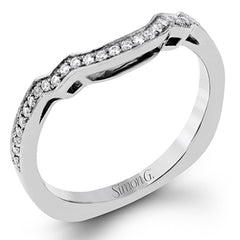 Featuring an impressive modern design, this white gold ring features .53 ctw emerald cut stone sides and .46 ctw round cut white diamonds.