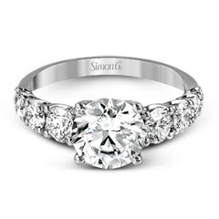 This white gold engagement ring's sophisticated, contemporary design glitters with 1.14 ctw of round white diamonds flanking the center stone.