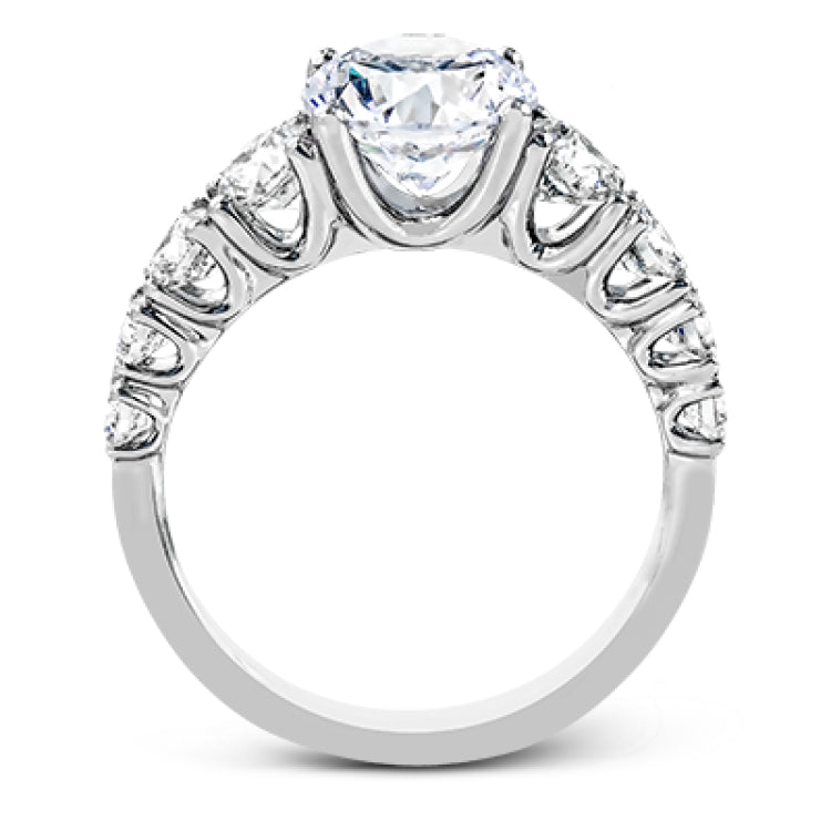 This white gold engagement ring's sophisticated, contemporary design glitters with 1.14 ctw of round white diamonds flanking the center stone.