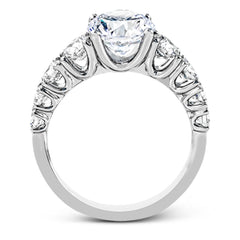 This white gold engagement ring's sophisticated, contemporary design glitters with 1.14 ctw of round white diamonds flanking the center stone.