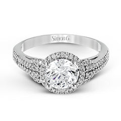 This 18k white gold ring contains .30 ctw of side diamonds set within its classic halo design.