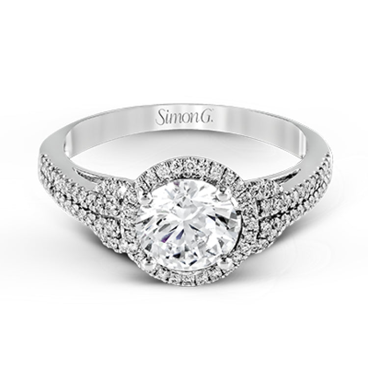 This 18k white gold ring contains .30 ctw of side diamonds set within its classic halo design.