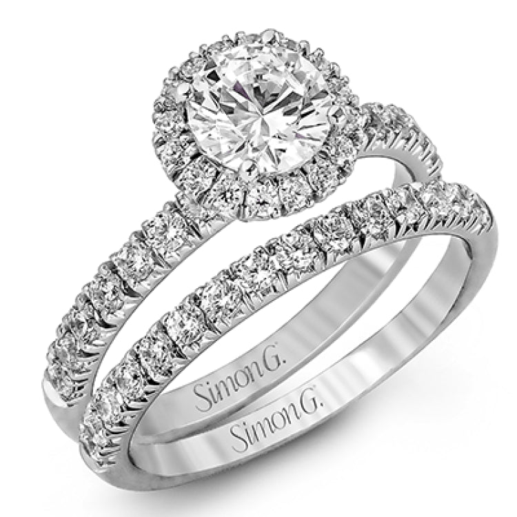 The classic halo design of this white gold engagement ring and wedding band are elevated by .80 ctw of shimmering round cut white diamonds.