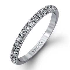 The classic halo design of this white gold engagement ring and wedding band are elevated by .80 ctw of shimmering round cut white diamonds.