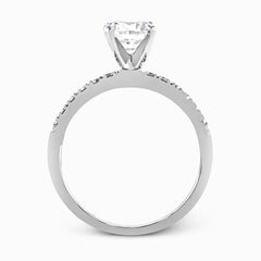 Featuring a modern take on a classic design, this white gold engagement ring and wedding band are inset with .58 ctw of glimmering round cut white diamonds.