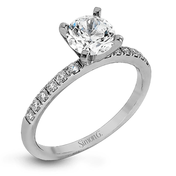 Featuring a modern take on a classic design, this white gold engagement ring and wedding band are inset with .58 ctw of glimmering round cut white diamonds.