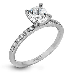 Featuring a modern take on a classic design, this white gold engagement ring and wedding band are inset with .58 ctw of glimmering round cut white diamonds.