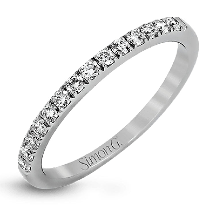 Featuring a modern take on a classic design, this white gold engagement ring and wedding band are inset with .58 ctw of glimmering round cut white diamonds.