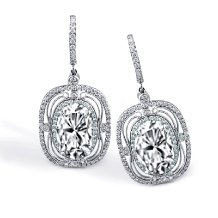 These exquisite vintage-inspired 18k white gold earrings contain delicate filigree and 1.12 ctw of white diamonds surrounding a gorgeous 7.12 ctw of green tourmaline.