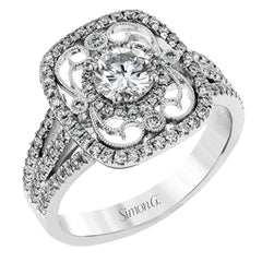 Reflecting an intricate vintage-inspired design, this three-tone gold ring is set with .61 ctw round cut white diamonds and a .53 ctw yellow oval diamond.