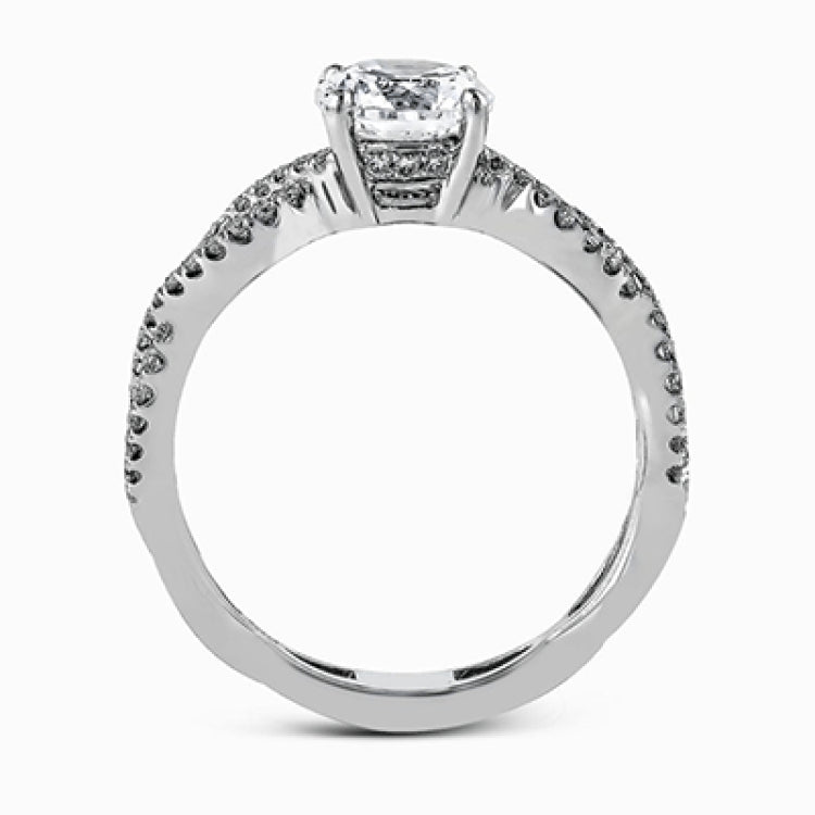 The intricate twisted design of this modern white gold engagement ring and wedding band set is set with .65 ctw of striking round cut white diamonds.