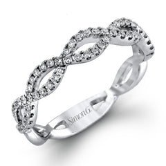 The intricate twisted design of this modern white gold engagement ring and wedding band set is set with .65 ctw of striking round cut white diamonds.