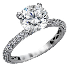 Presenting an eye-catching modern design, this white gold engagement ring and wedding band are highlighted by 1.45 ctw of round cut white diamonds.
