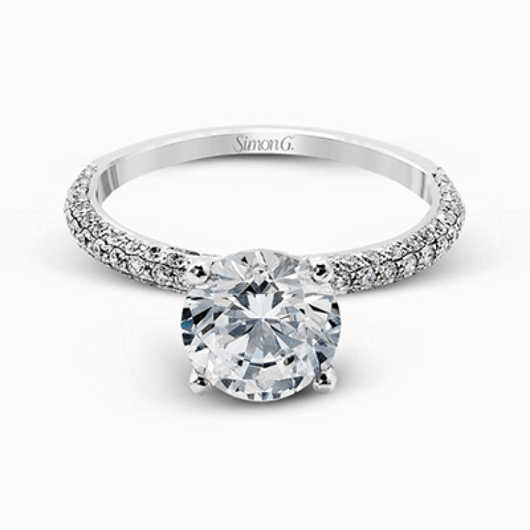 Presenting an eye-catching modern design, this white gold engagement ring and wedding band are highlighted by 1.45 ctw of round cut white diamonds.