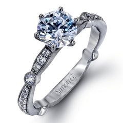 Featuring a dazzling contemporary design, this elegant white gold engagement ring and wedding band set is accented by .59 ctw of round cut white diamonds.