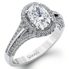 This lovely 18k white gold engagement ring design is created for an elegant oval center stone and features .77 ctw of white diamonds accented by a small touch of .03 ctw of yellow diamonds.