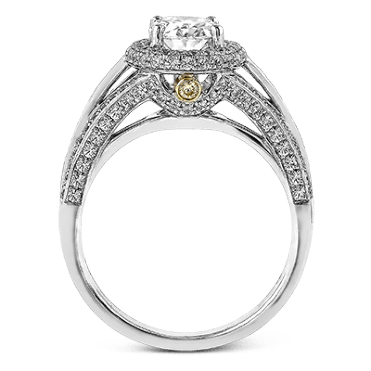 This lovely 18k white gold engagement ring design is created for an elegant oval center stone and features .77 ctw of white diamonds accented by a small touch of .03 ctw of yellow diamonds.