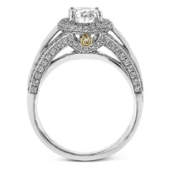 This lovely 18k white gold engagement ring design is created for an elegant oval center stone and features .77 ctw of white diamonds accented by a small touch of .03 ctw of yellow diamonds.