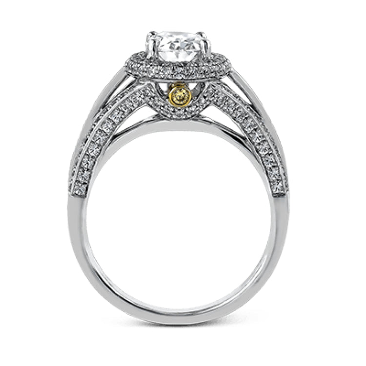 This lovely 18k white gold engagement ring design is created for an elegant oval center stone and features .77 ctw of white diamonds accented by a small touch of .03 ctw of yellow diamonds.